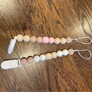 Two silicone pacifier holders, used once